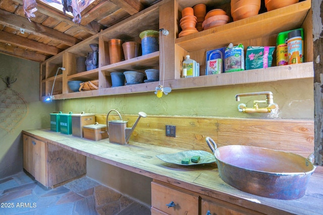 kitchen featuring beamed ceiling, built in desk, and wooden ceiling