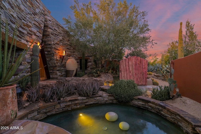 view of pool at dusk