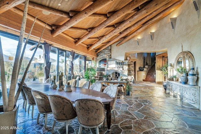 dining area featuring wood ceiling, high vaulted ceiling, and beamed ceiling