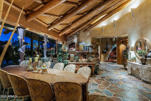 dining room with high vaulted ceiling, wooden ceiling, and beamed ceiling