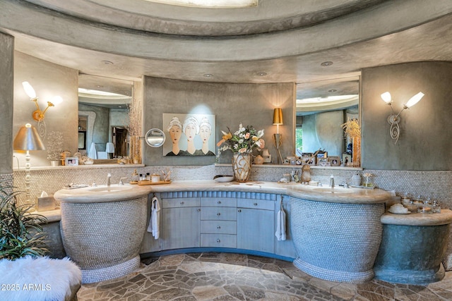 bathroom with vanity and decorative backsplash