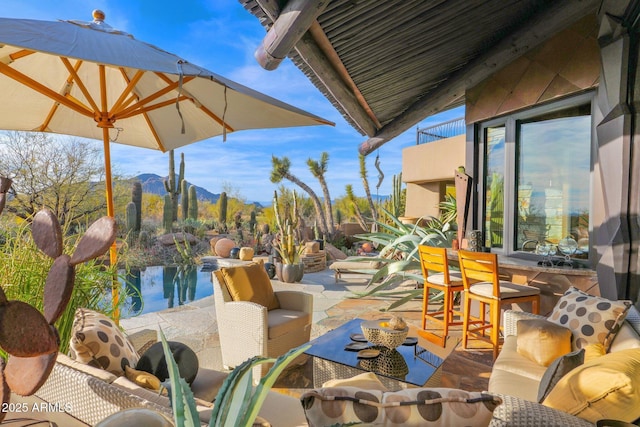 view of patio with a mountain view and an outdoor living space