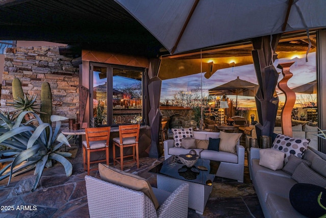 patio terrace at dusk featuring an outdoor hangout area