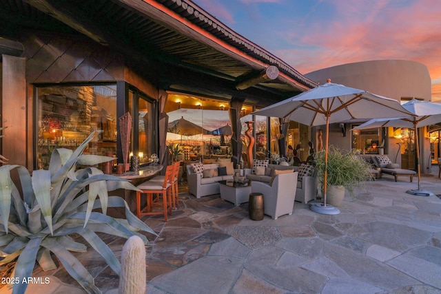 patio terrace at dusk featuring an outdoor hangout area