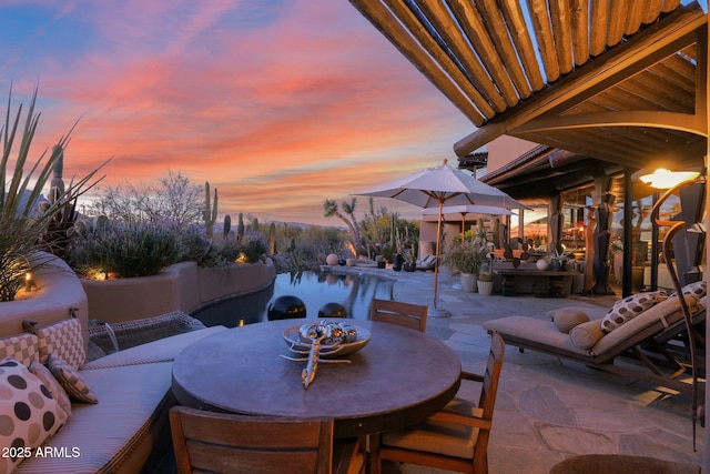 view of patio terrace at dusk