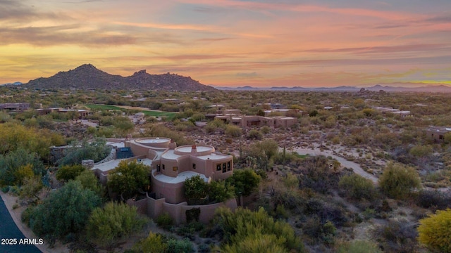 aerial view at dusk featuring a mountain view