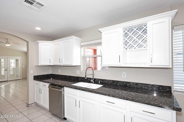 kitchen with white cabinetry, ceiling fan, dishwasher, sink, and dark stone countertops