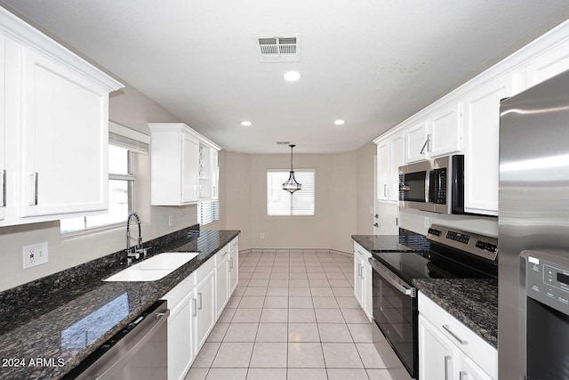 kitchen with white cabinets, sink, hanging light fixtures, and appliances with stainless steel finishes