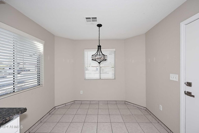 unfurnished dining area featuring light tile patterned floors and a healthy amount of sunlight