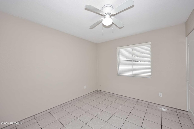 unfurnished room featuring ceiling fan and light tile patterned floors