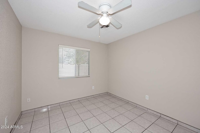 tiled empty room with ceiling fan