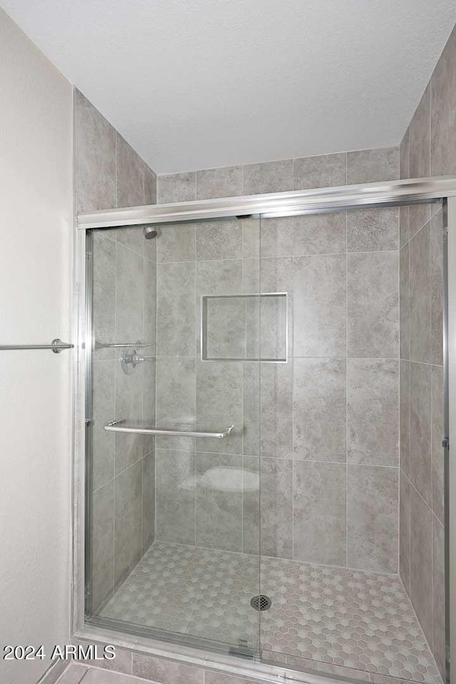 bathroom with a shower with door