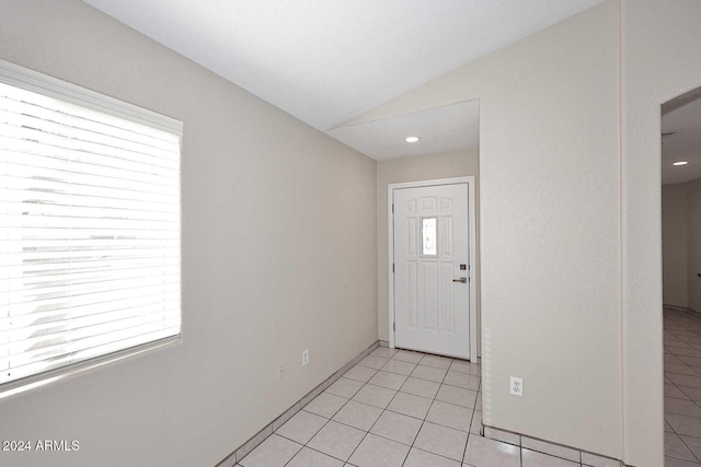 tiled entrance foyer with vaulted ceiling