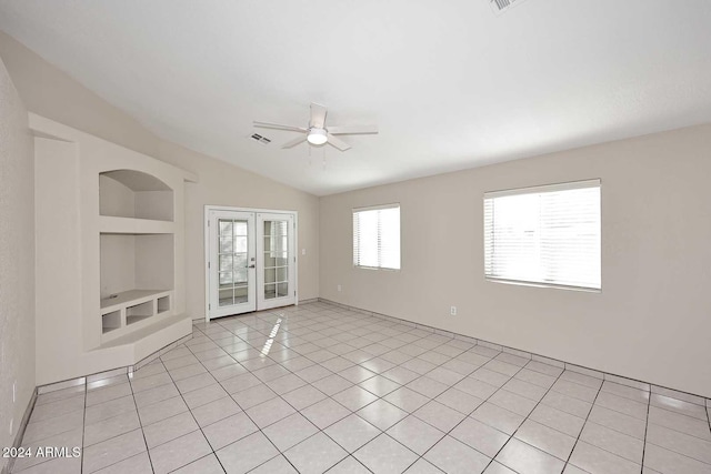 spare room with french doors, light tile patterned floors, built in features, and ceiling fan