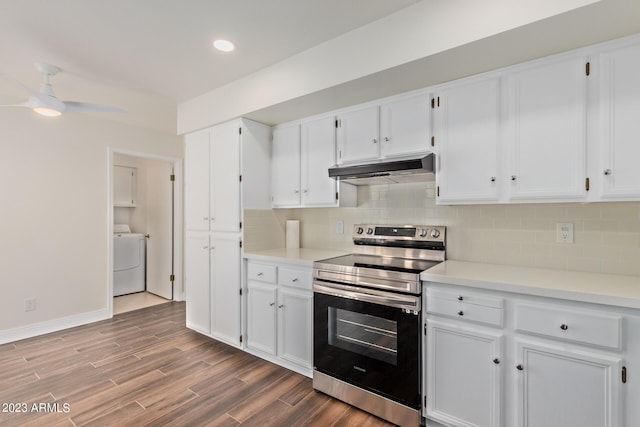 kitchen featuring white cabinetry, tasteful backsplash, stainless steel range with electric cooktop, under cabinet range hood, and washer / dryer