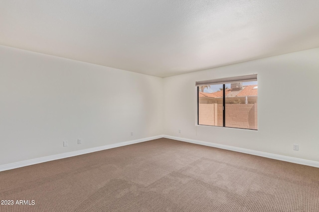empty room with carpet flooring and baseboards