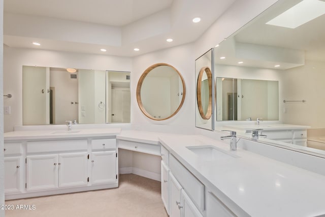 full bathroom with tile patterned floors, recessed lighting, a skylight, and a sink