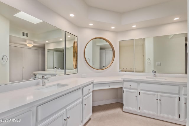 full bath featuring recessed lighting, two vanities, tile patterned flooring, and a sink