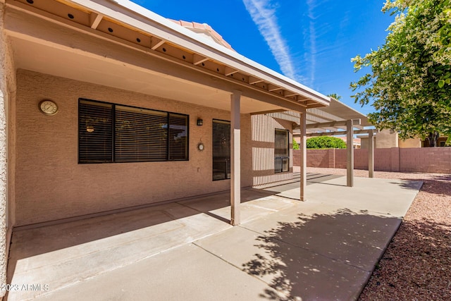 view of patio featuring fence