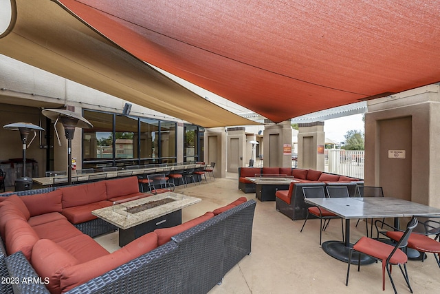 view of patio / terrace with an outdoor living space with a fire pit