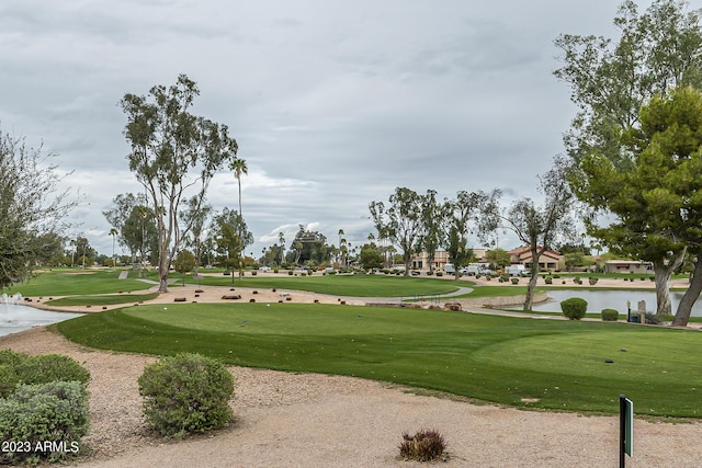 view of property's community with a lawn and golf course view