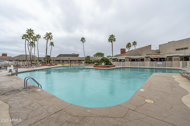 community pool featuring a patio and fence
