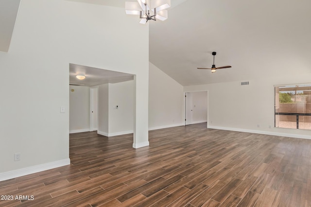 unfurnished living room with visible vents, ceiling fan with notable chandelier, dark wood-style floors, and baseboards