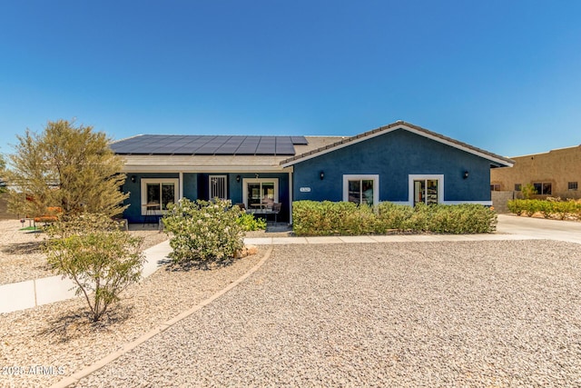 5321 N 196th Ave, Litchfield Park, AZ 85340 - ranch-style home with a porch, solar panels, and stucco siding