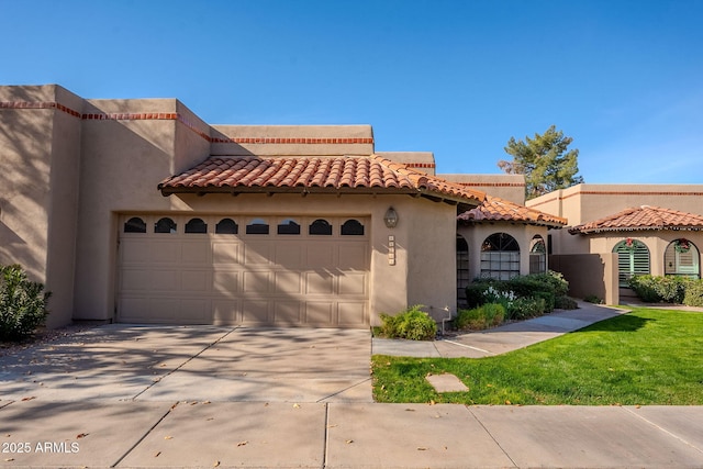 mediterranean / spanish-style home with a garage