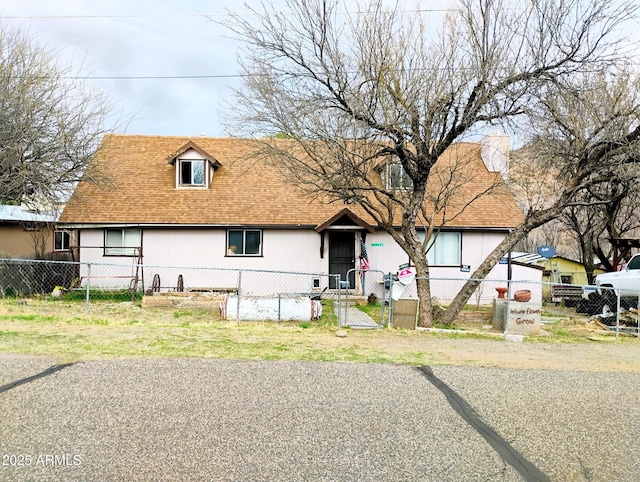 11150 E Clatterbuck Dr, Cornville, AZ 86325 - view of front of house with a fenced front yard, a shingled roof, a gate, and a chimney