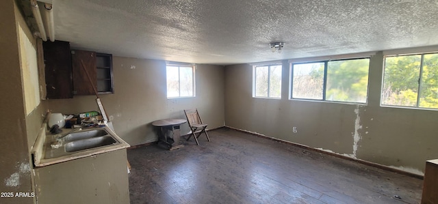 11150 E Clatterbuck Dr, Cornville, AZ 86325 - kitchen with a textured ceiling, a sink, hardwood / wood-style flooring, and baseboards