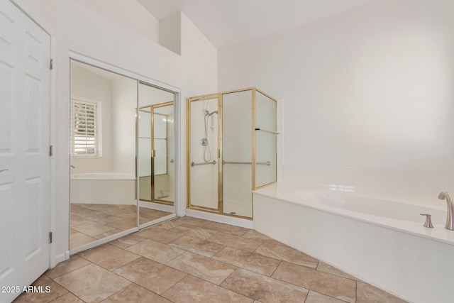 bathroom featuring tile patterned floors and independent shower and bath