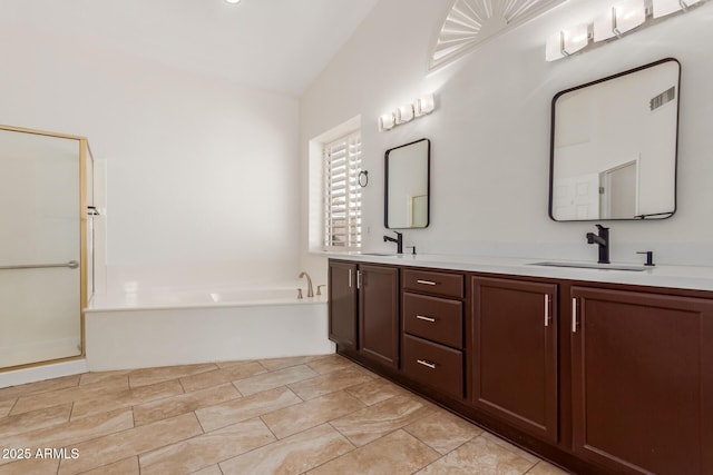 bathroom featuring vanity, separate shower and tub, and vaulted ceiling