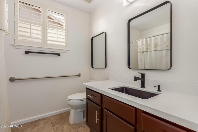 bathroom with vanity, tile patterned flooring, and toilet