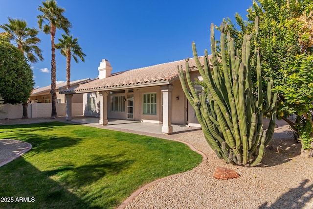 back of house with a yard and a patio area