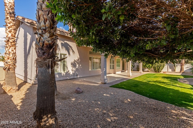 exterior space with a patio area and a lawn