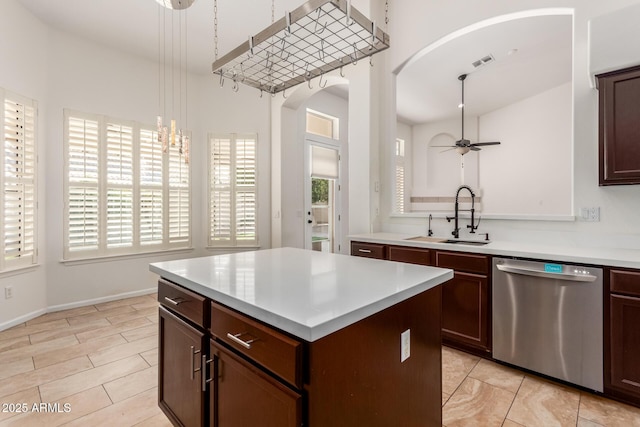 kitchen featuring sink, decorative light fixtures, dishwasher, a kitchen island, and ceiling fan