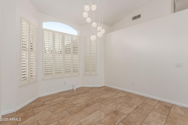 empty room featuring lofted ceiling and a notable chandelier