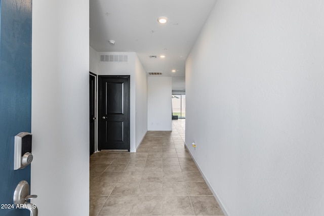 corridor featuring light tile patterned floors