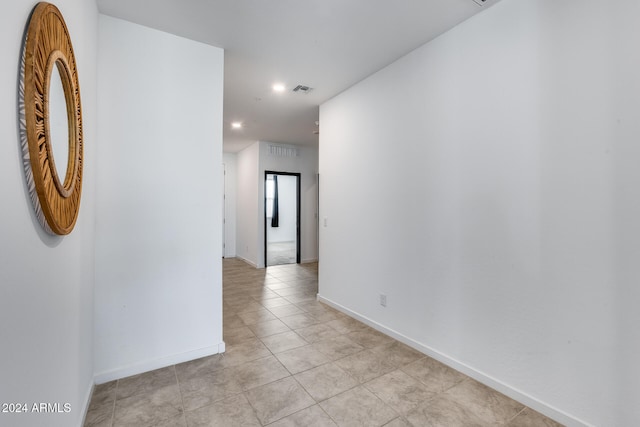 hall featuring light tile patterned flooring