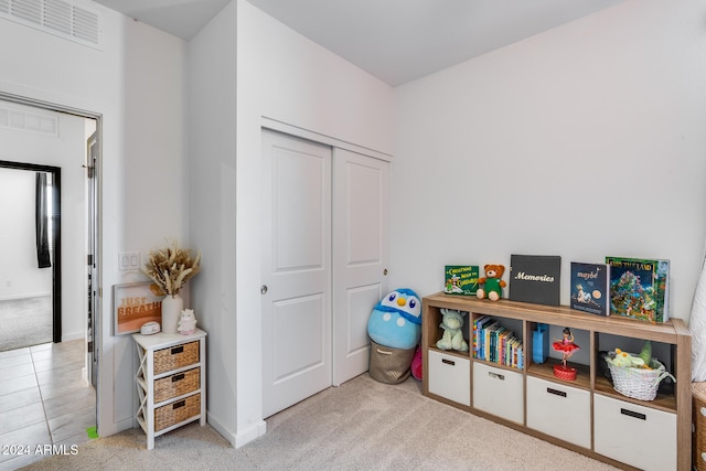 recreation room featuring light colored carpet