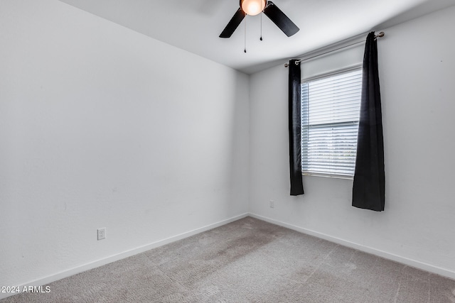 spare room featuring ceiling fan and carpet floors