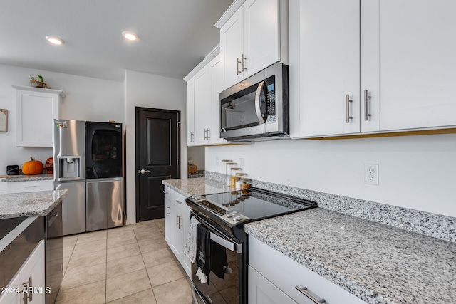 kitchen featuring white cabinetry, light stone counters, and stainless steel appliances