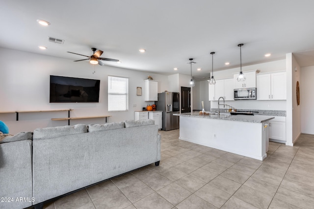 living room featuring light tile patterned flooring, sink, and ceiling fan