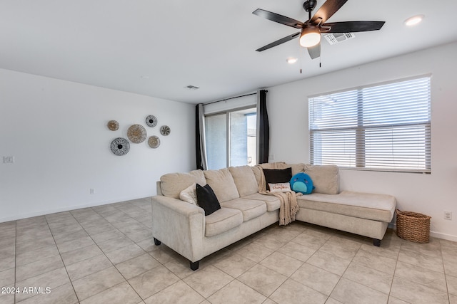 tiled living room featuring ceiling fan