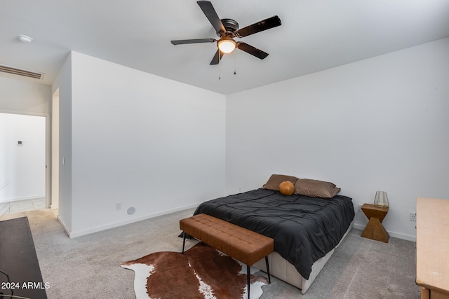 bedroom featuring light carpet and ceiling fan