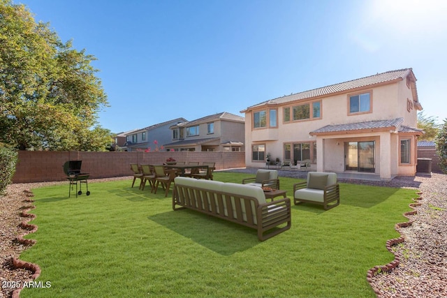 back of house featuring a lawn and outdoor lounge area