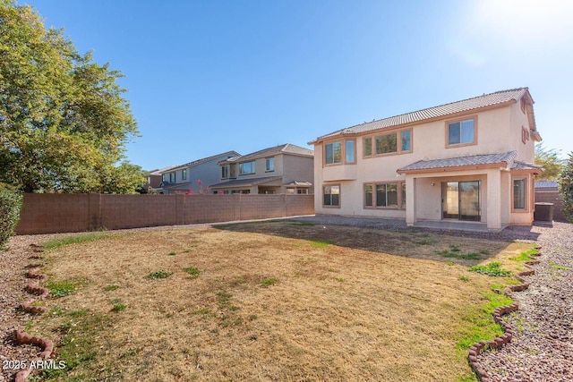 back of property featuring a lawn