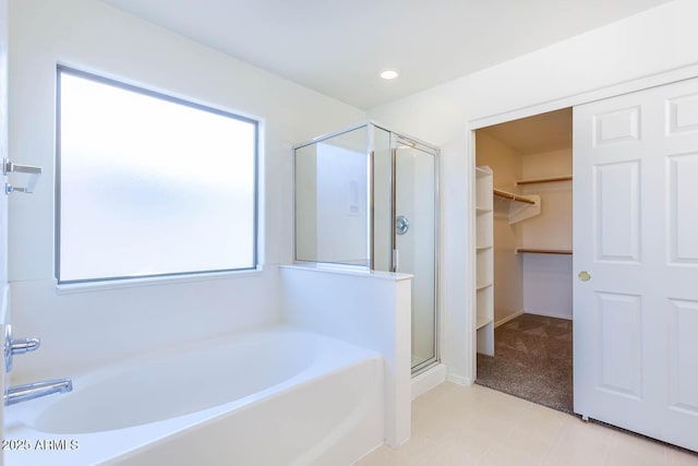 bathroom featuring a wealth of natural light and plus walk in shower