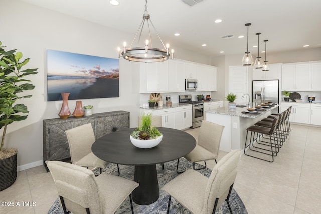 tiled dining room with an inviting chandelier